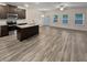 Open concept kitchen with island, stainless steel appliances, and hardwood floors at 5120 Lower Elm St, Atlanta, GA 30349