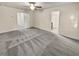 Main bedroom with carpet, ceiling fan, and access to bathroom at 5120 Lower Elm St, Atlanta, GA 30349