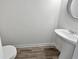 Small bathroom with pedestal sink, toilet, and gray tile floor at 5120 Lower Elm St, Atlanta, GA 30349