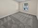 Spacious bedroom with neutral walls and grey carpeting at 5120 Lower Elm St, Atlanta, GA 30349
