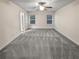 Spacious main bedroom with neutral-colored carpet and plenty of natural light from two large windows at 5120 Lower Elm St, Atlanta, GA 30349