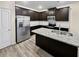 Modern kitchen with dark cabinets, granite countertops, and stainless steel appliances at 5120 Lower Elm St, Atlanta, GA 30349