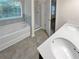 Bathroom with a large soaking tub, separate shower, and double vanity at 5120 Lower Elm St, Atlanta, GA 30349