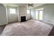 Spacious Gathering room with fireplace and carpet flooring, access to backyard at 2469 Osceola Rd, Lithonia, GA 30058