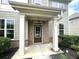 Brick front porch with columns and a dark green front door at 2469 Osceola Rd, Lithonia, GA 30058