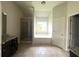Main bathroom with double vanity, shower, and tile floors at 2469 Osceola Rd, Lithonia, GA 30058