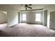 Large main bedroom with ceiling fan and carpeted floors at 2469 Osceola Rd, Lithonia, GA 30058
