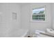 Renovated bathroom featuring subway tile shower and window at 5506 Alder Dr, Forest Park, GA 30297