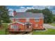 Rear view of brick house with deck and spacious backyard at 2505 Westchester Way, Conyers, GA 30013