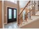 Elegant entryway with double doors and a grand staircase at 2505 Westchester Way, Conyers, GA 30013