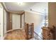 Elegant hardwood floors in upstairs hallway with a chandelier at 2505 Westchester Way, Conyers, GA 30013