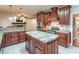 Island kitchen features granite countertops, custom cabinetry, and stainless steel appliances at 2505 Westchester Way, Conyers, GA 30013