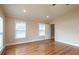 Spacious bedroom with hardwood floors and multiple windows at 2505 Westchester Way, Conyers, GA 30013