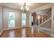 Elegant dining room with hardwood floors, large windows, and a chandelier at 2505 Westchester Way, Conyers, GA 30013