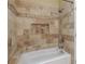 Bathroom with tiled shower/tub combo and decorative tile at 2505 Westchester Way, Conyers, GA 30013