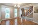 Bright dining room with hardwood floors and view into living room at 2505 Westchester Way, Conyers, GA 30013