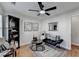 Sitting room with black couch, wood floors, and ceiling fan at 3676 Chattahoochee Summit Dr, Atlanta, GA 30339