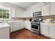 Kitchen with white cabinets, stainless steel appliances, and hardwood floors at 1812 Beckley Nw Pl, Kennesaw, GA 30152