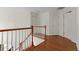 Upper hallway with hardwood floors and access to bedrooms at 1812 Beckley Nw Pl, Kennesaw, GA 30152