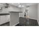 Basement wet bar with black countertop and white cabinets at 1812 Beckley Nw Pl, Kennesaw, GA 30152