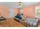 Peach colored basement bedroom with hardwood floors at 1812 Beckley Nw Pl, Kennesaw, GA 30152