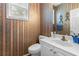 Small bathroom with white vanity and floral wallpaper at 1812 Beckley Nw Pl, Kennesaw, GA 30152