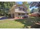 Side view of the home featuring a two-car garage and landscaping at 486 Oroarke Dr, Stone Mountain, GA 30088