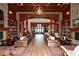 Large community room with hardwood floors, comfortable seating areas, and a fireplace at 418 Laurel Spring Ct, Canton, GA 30114