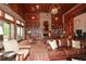 Bright community room with leather couches, built-in bookshelves, and a fireplace at 418 Laurel Spring Ct, Canton, GA 30114
