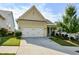 House exterior with a two-car garage and neatly landscaped front yard at 418 Laurel Spring Ct, Canton, GA 30114