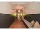 Elegant hallway with dark wainscoting, hardwood floors, and a comfortable bench at 418 Laurel Spring Ct, Canton, GA 30114