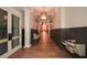 Hallway with hardwood floors, a built-in bench, and access to the community kitchen at 418 Laurel Spring Ct, Canton, GA 30114