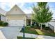 House exterior featuring a two-car garage and manicured landscaping at 418 Laurel Spring Ct, Canton, GA 30114