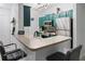 Modern kitchen with teal cabinets, stainless steel appliances, and breakfast bar at 2700 Pine Tree Ne Rd # 2108, Atlanta, GA 30324