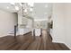 Open concept kitchen and dining area with white cabinets, island, and stainless steel appliances at 6005 Skellig St, Norcross, GA 30071