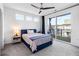 Spacious bedroom with a blue bed, sliding glass door, and ceiling fan at 395 Pratt Drive Se, Unit #802, Atlanta, GA 30315