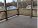 Covered deck overlooking wooded area with distant home views at 2235 Windsor Bluffs Dr, Cumming, GA 30041