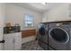 Bright laundry room with washer, dryer, and utility sink at 2912 Vinings Forest Se Way, Atlanta, GA 30339