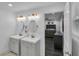 Modern bathroom with dual sinks, tiled floor, and a view of the bedroom at 287 Church St, Dacula, GA 30019