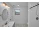 Bright bathroom featuring a shower, toilet, and updated vanity at 287 Church St, Dacula, GA 30019