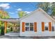 Side view of a white house with wooden accents, showcasing the home's clean lines and modern style at 287 Church St, Dacula, GA 30019