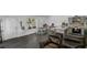 Open concept living room with a comfortable leather couch and a view into the kitchen and dining area at 287 Church St, Dacula, GA 30019