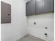 Laundry room with gray cabinets and tile flooring at 971 Washington Sw Pl, Atlanta, GA 30314