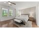 Main bedroom with hardwood floors, plantation shutters, and a ceiling fan at 1230 Harper Dr, Alpharetta, GA 30076