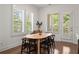 Dining area with oval wooden table and black chairs near sliding door at 1230 Harper Dr, Alpharetta, GA 30076