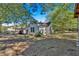 White house with a spacious backyard surrounded by trees at 5361 N Main St, Acworth, GA 30101