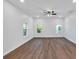 Large bedroom with hardwood floors and three windows at 5361 N Main St, Acworth, GA 30101