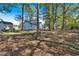 Large backyard with mature trees and a shed at 5361 N Main St, Acworth, GA 30101