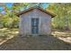 Wooden storage shed with a metal security door at 5361 N Main St, Acworth, GA 30101