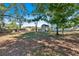 Large backyard with mature trees and a shed at 5361 N Main St, Acworth, GA 30101